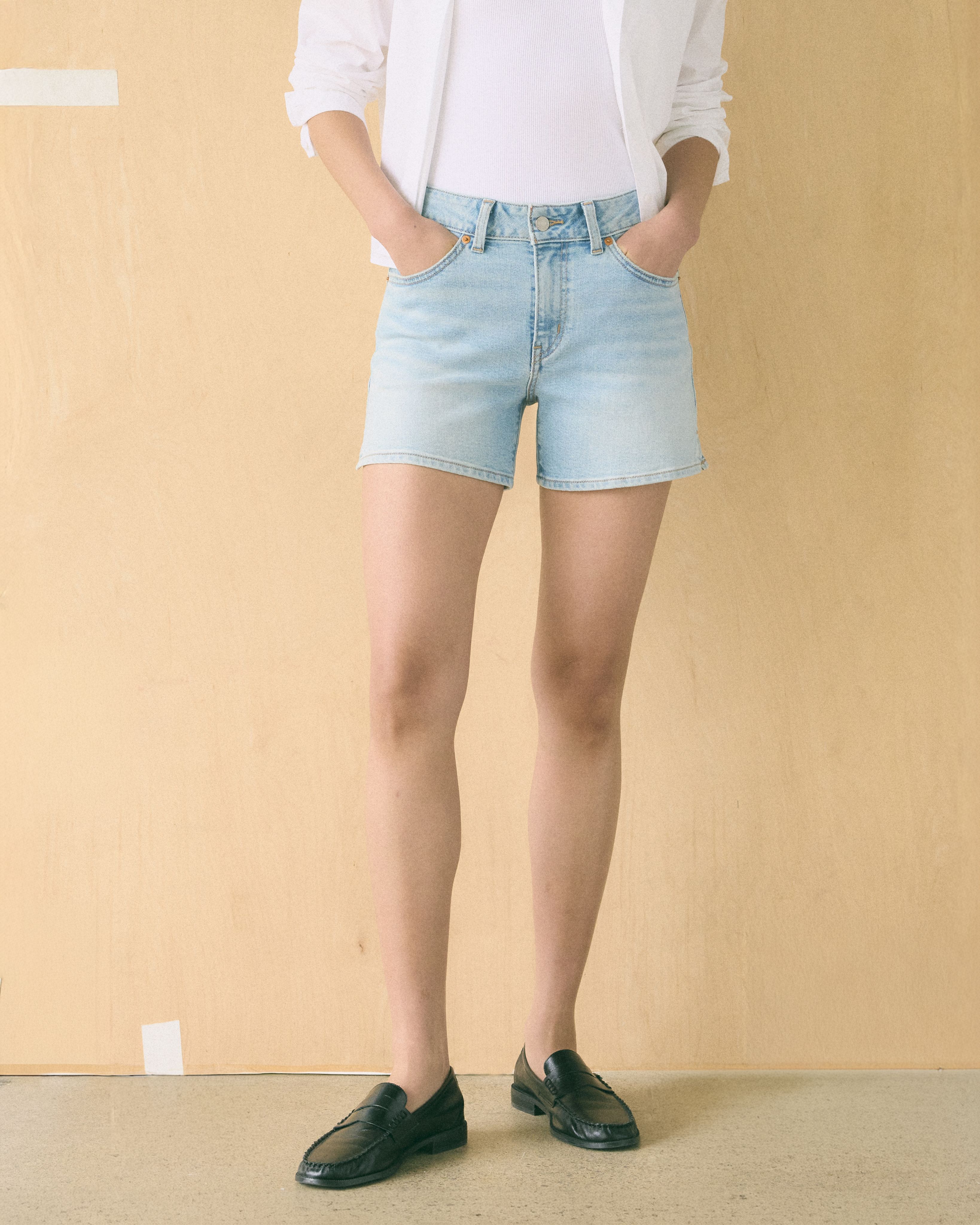 Model wearing mid rise shorts