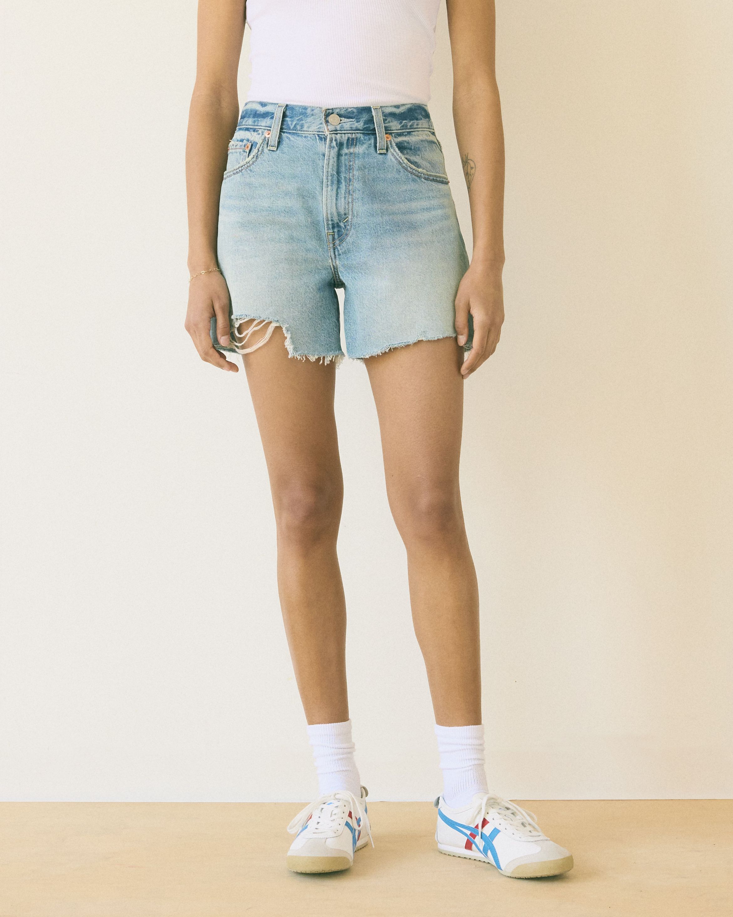 Model wearing high rise shorts