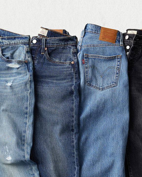 4 pairs of jeans laying next to each other 