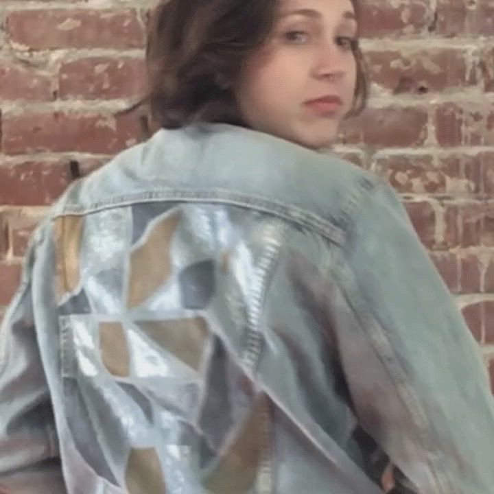 Video of Levi's® tailor, Jen Sharkey, smiling while holding up her newly designed trucker jacket and putting it on.
