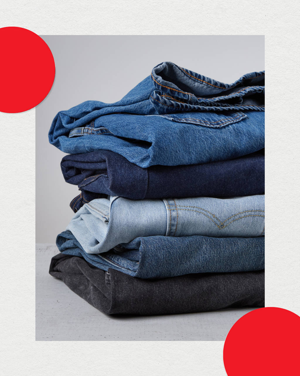 Multiple pairs of folded jeans stacked on top of each other