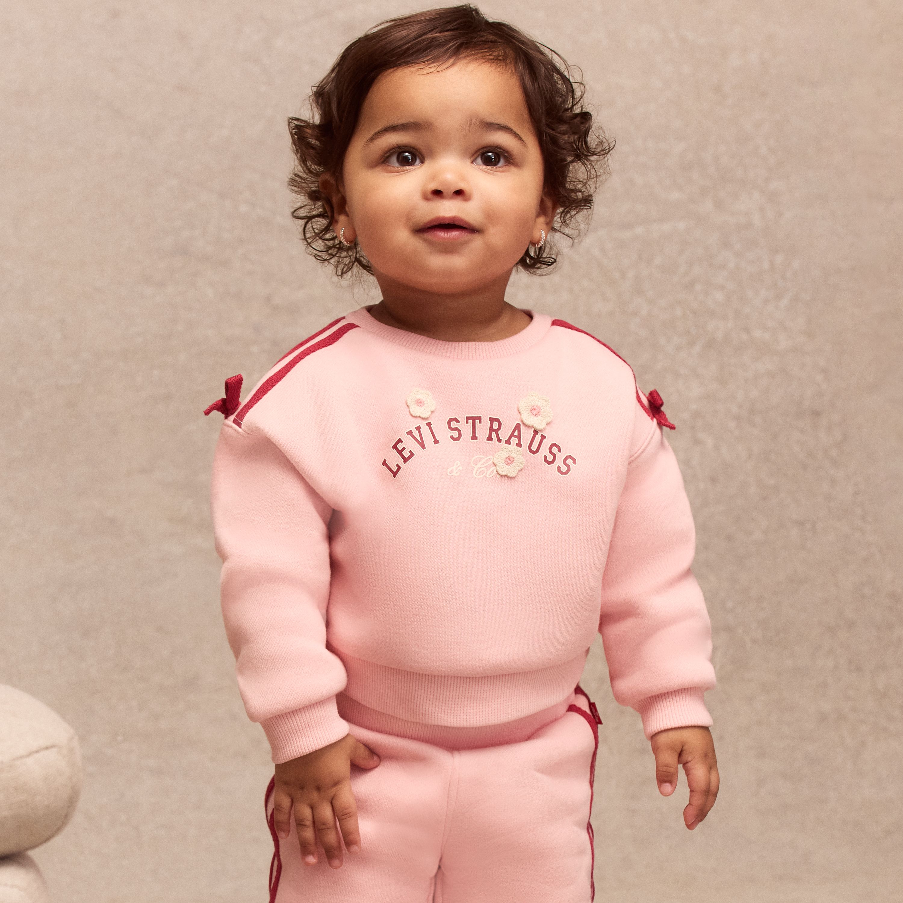 Little boy model wearing shorts and a tee.