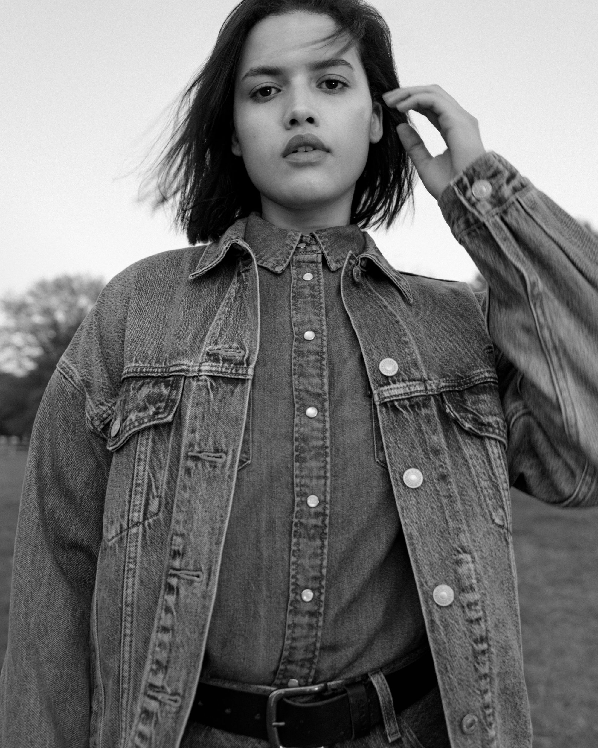 Black & white image of model in women's denim shirts