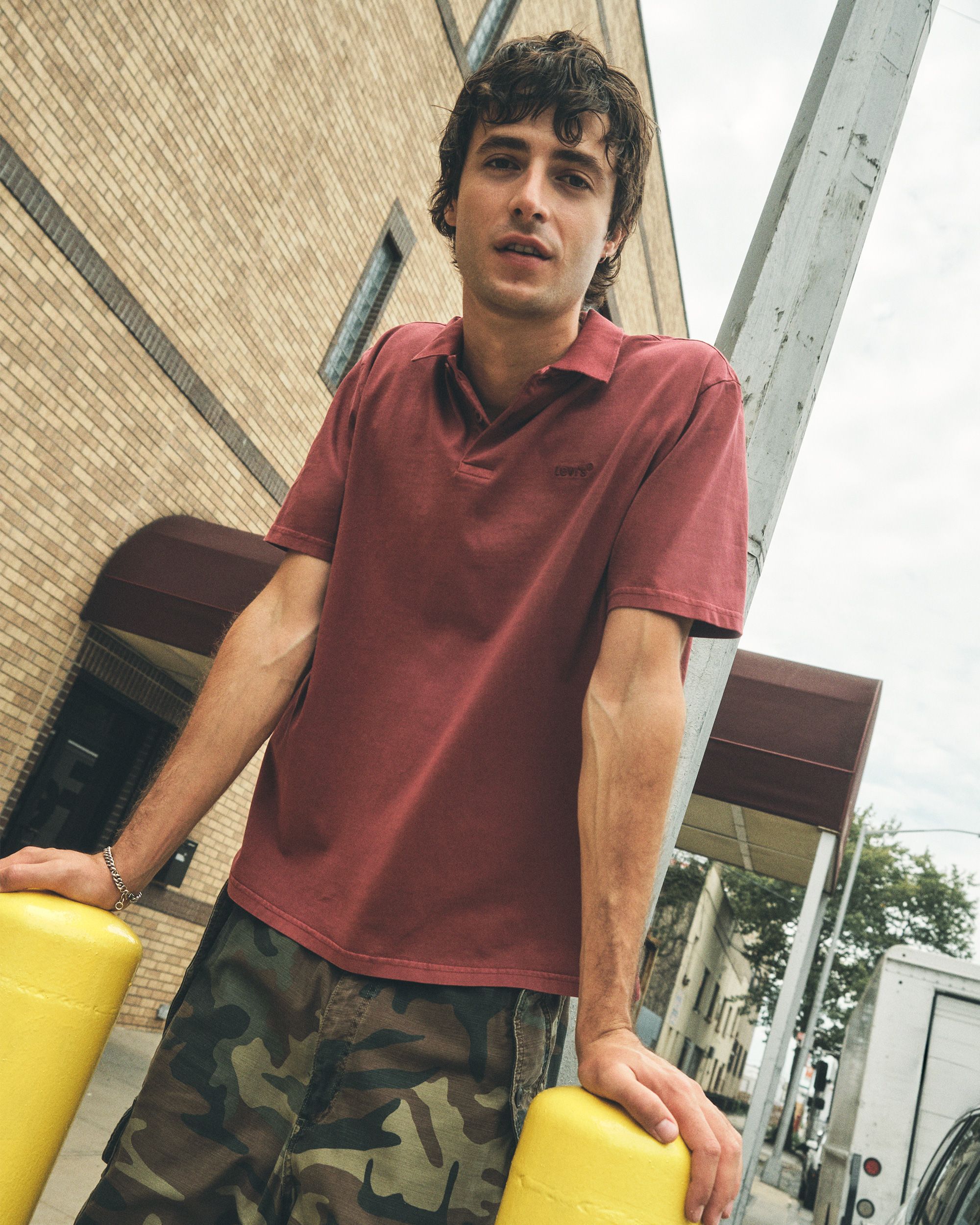 Model in men's red polo top