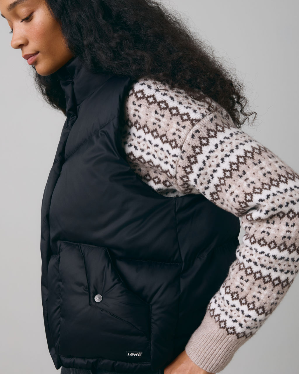 Model in black puffer vest