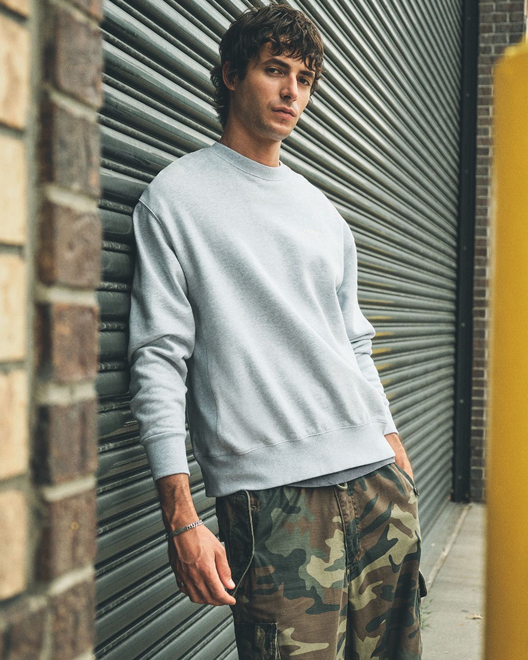 Model in grey garment dyed crew neck sweatshirt