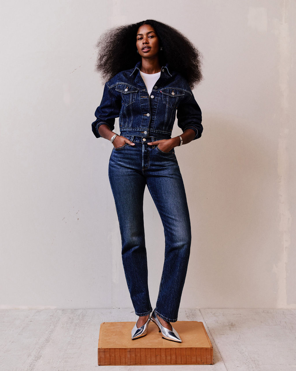Model in dark wash head to toe denim, wearing 501® Curve jeans