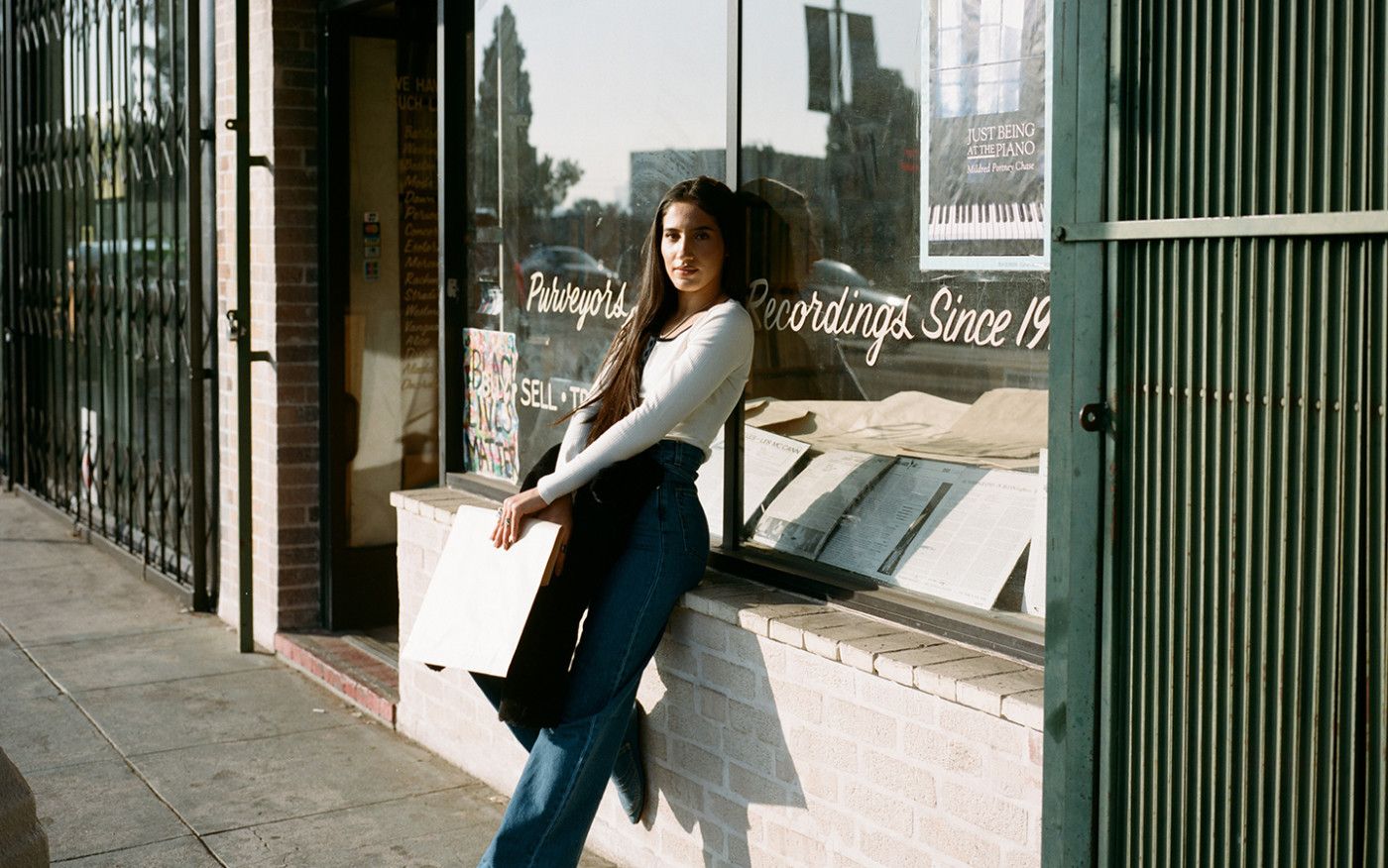 Photo of ABIR standing outside a record store.