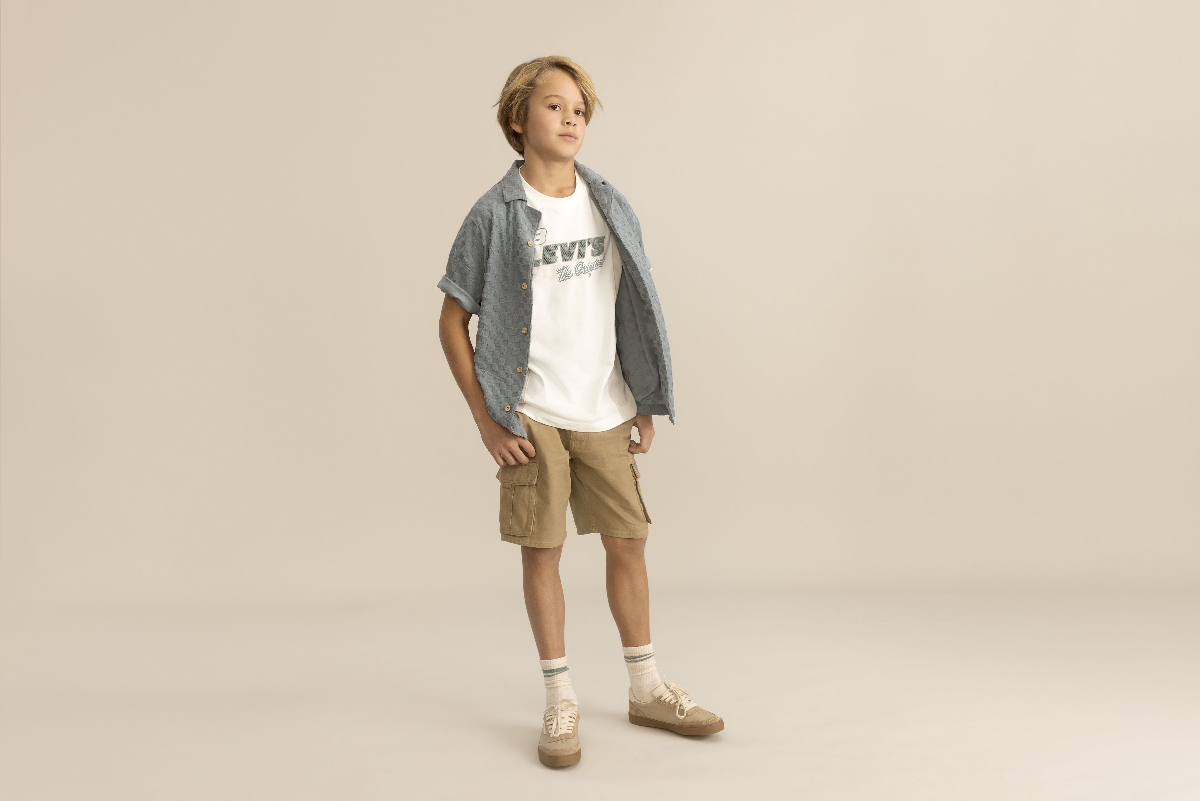 Big boy model wearing shorts and a tee.