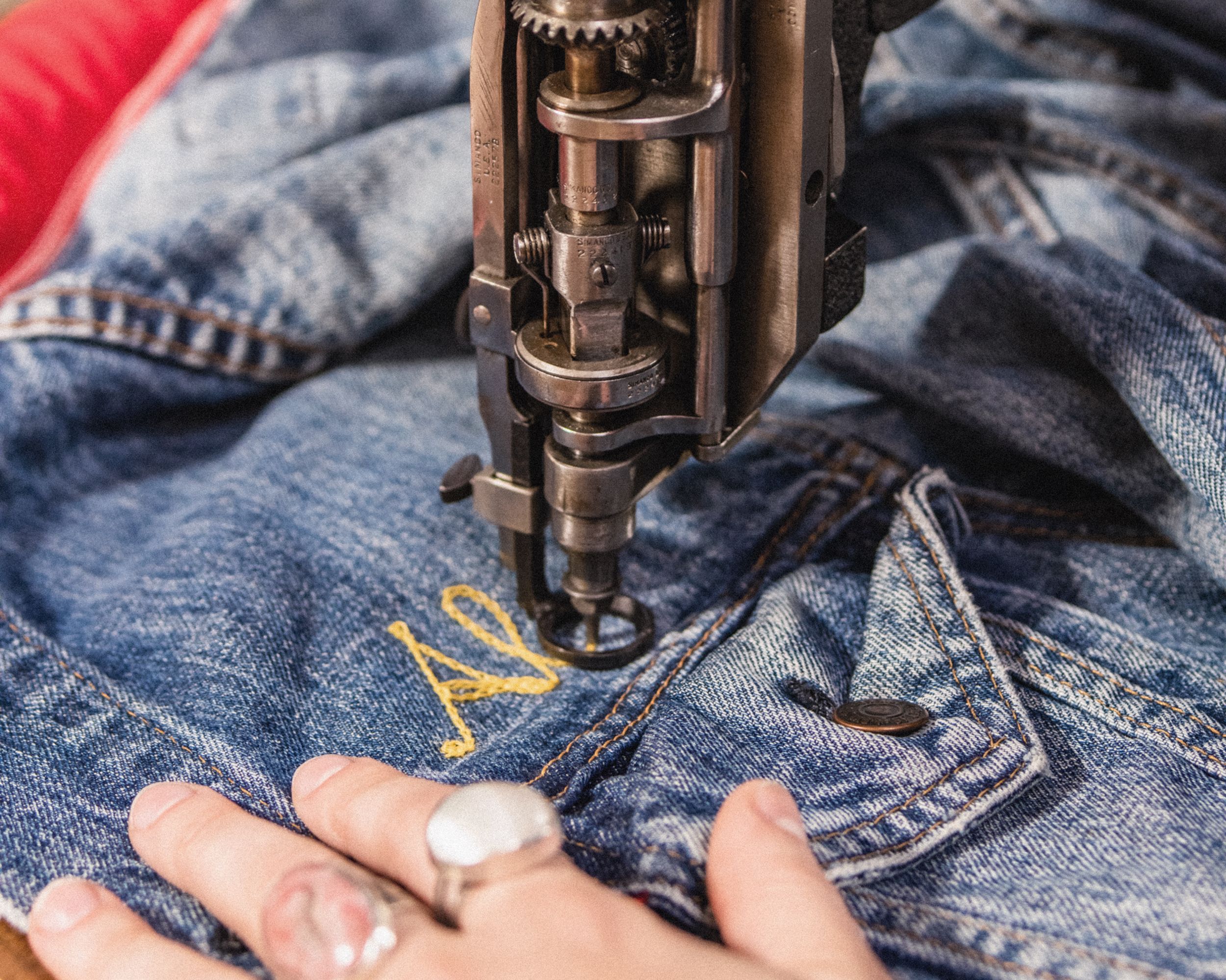 Trucker Jacket being embroidered with a name