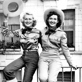 Two women sitting wearing Levi's.