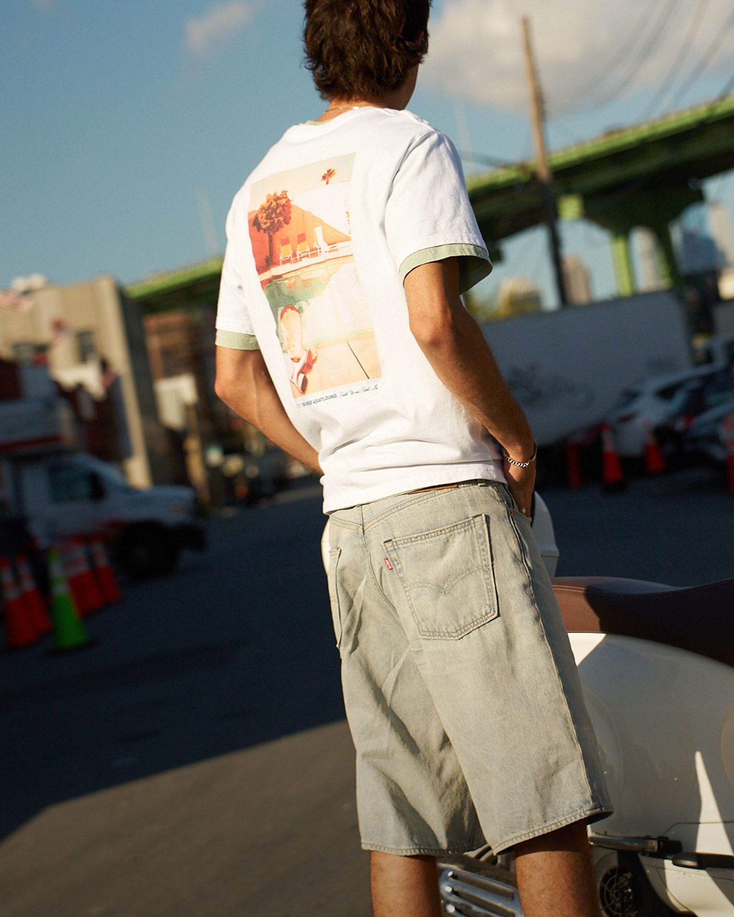 Backside shot of model in graphic tee