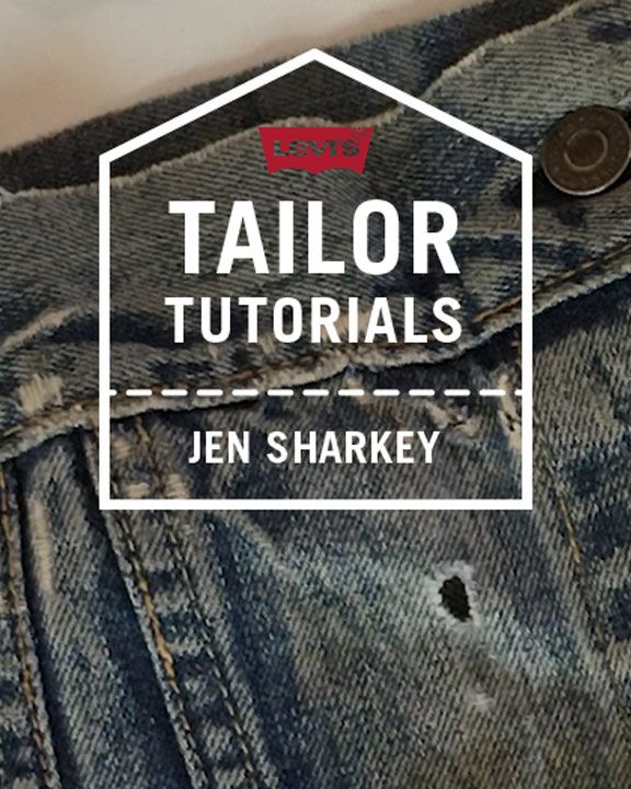 hand fixing hole in denim close up