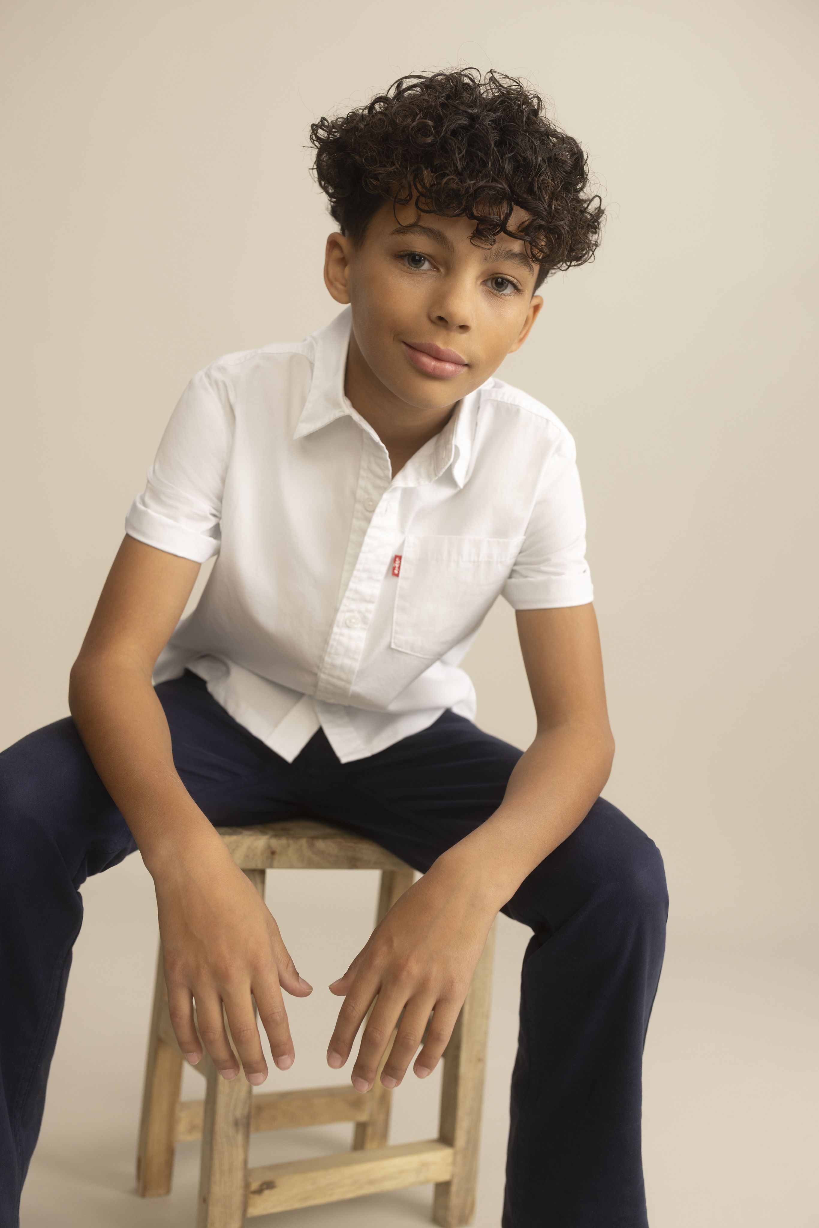 Little boy model wearing shorts and a tee.