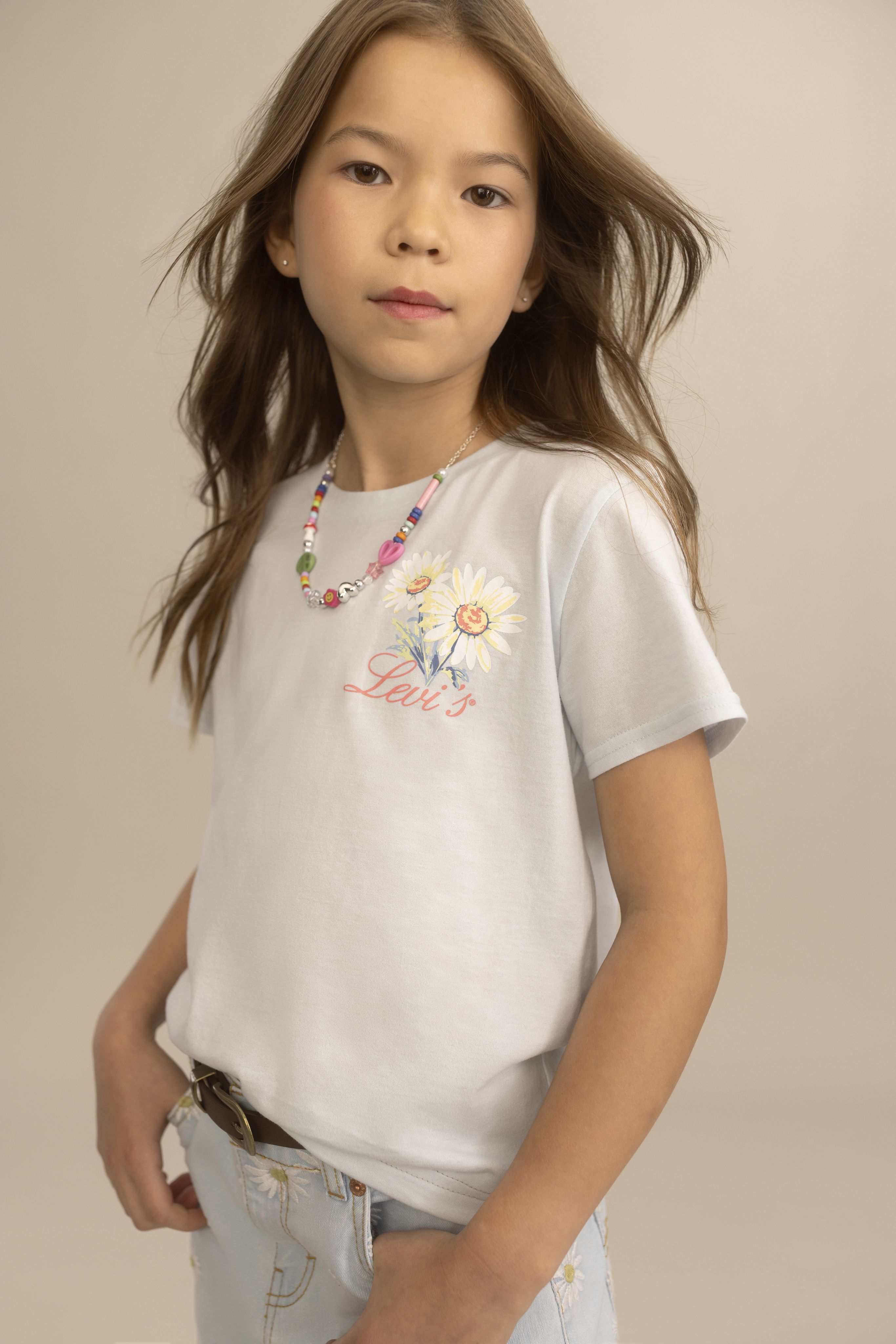 Little girl model wearing jacket and red tee.