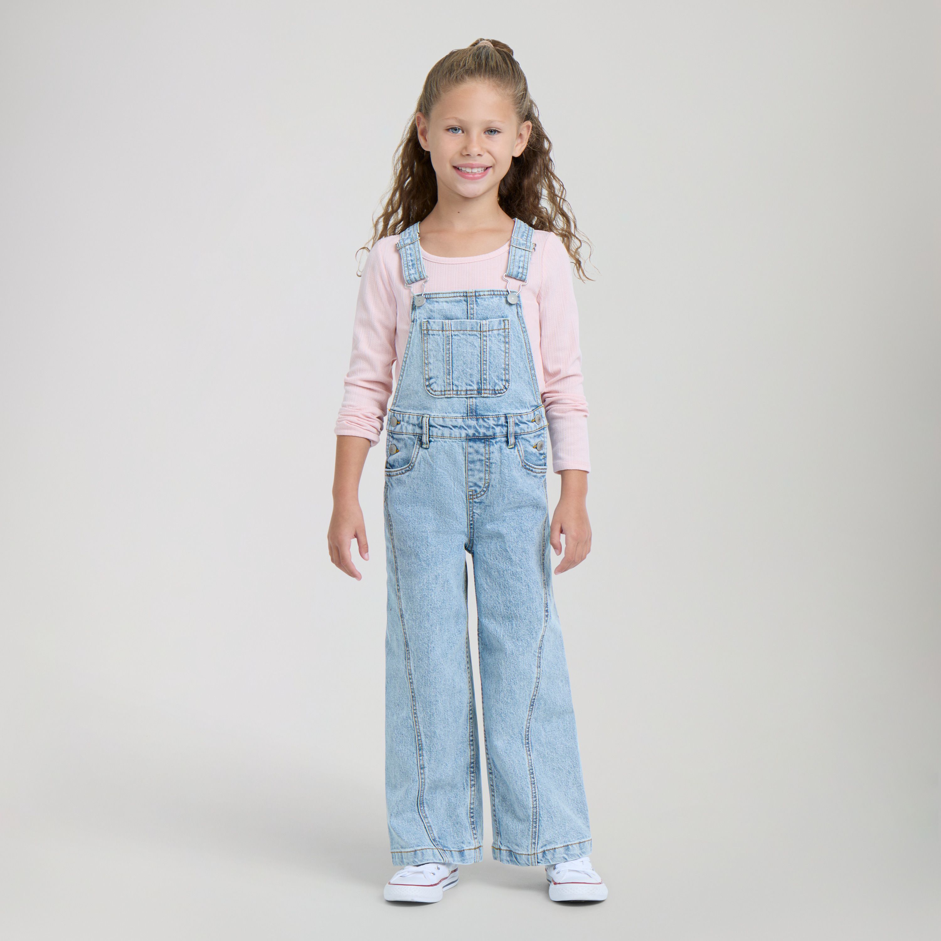 Little girl model wearing jacket and red tee.