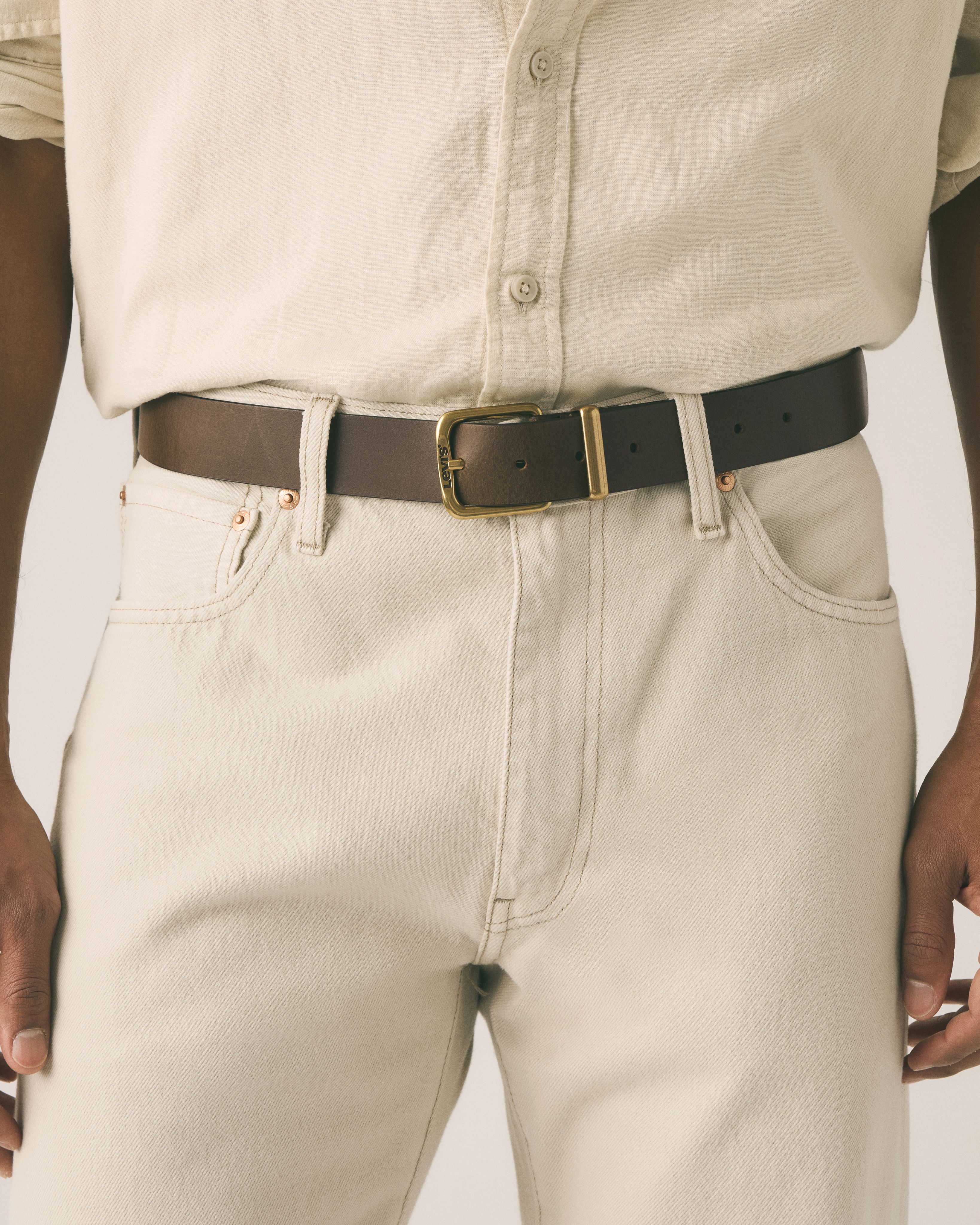 Brown belt rolled up with silver buckle.