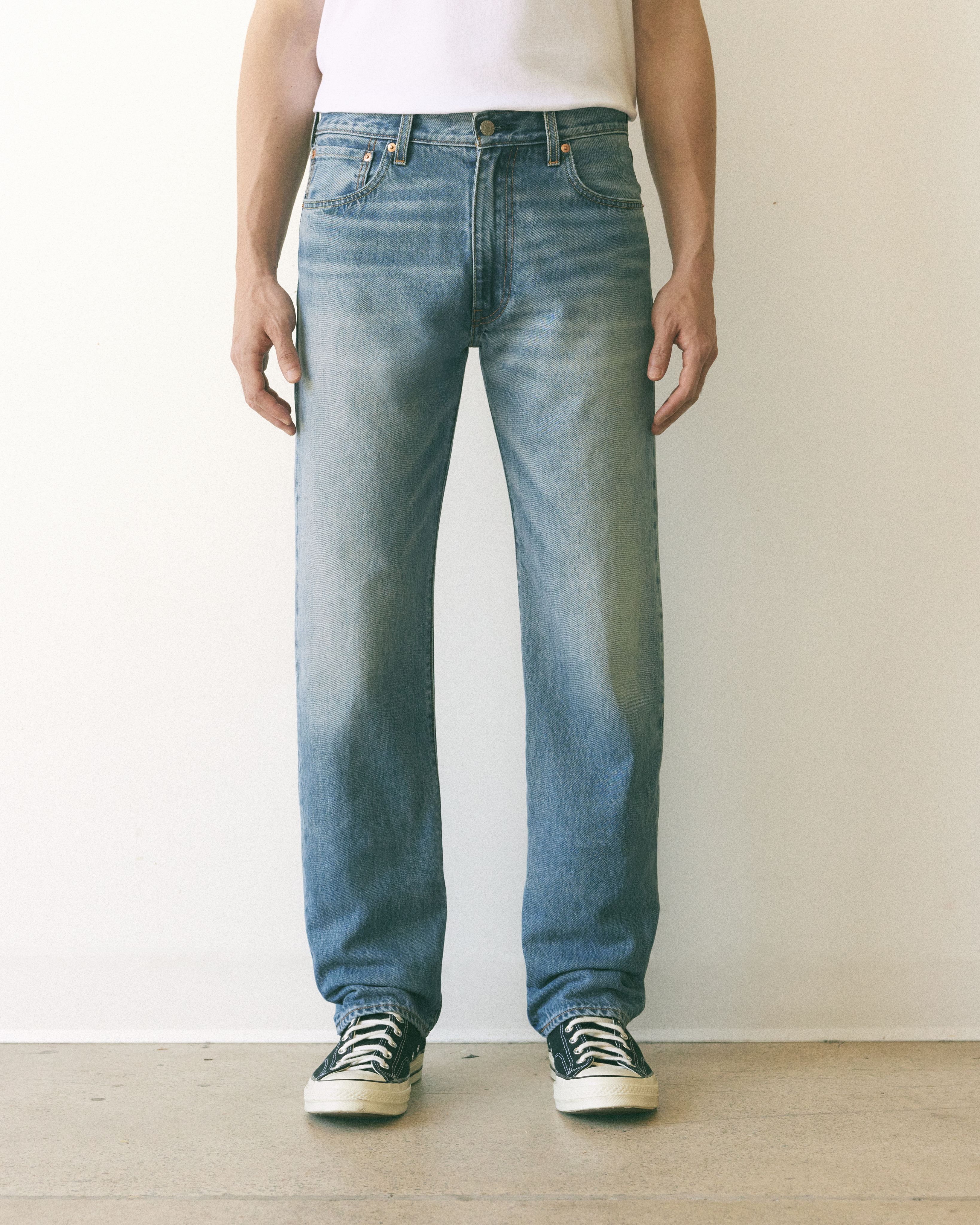 Model wearing tan relaxed fit pants.