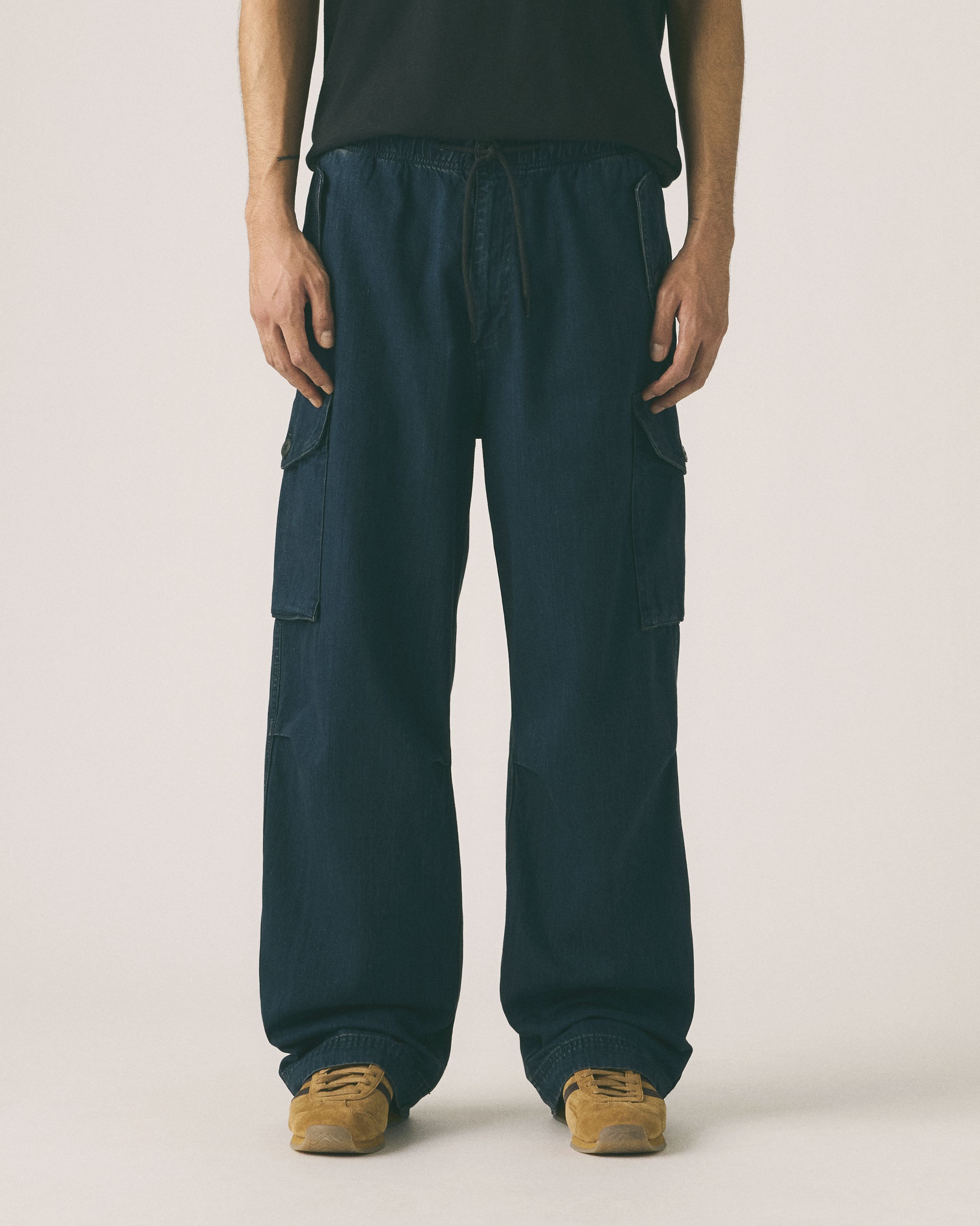 Model wearing grey sweatpants.