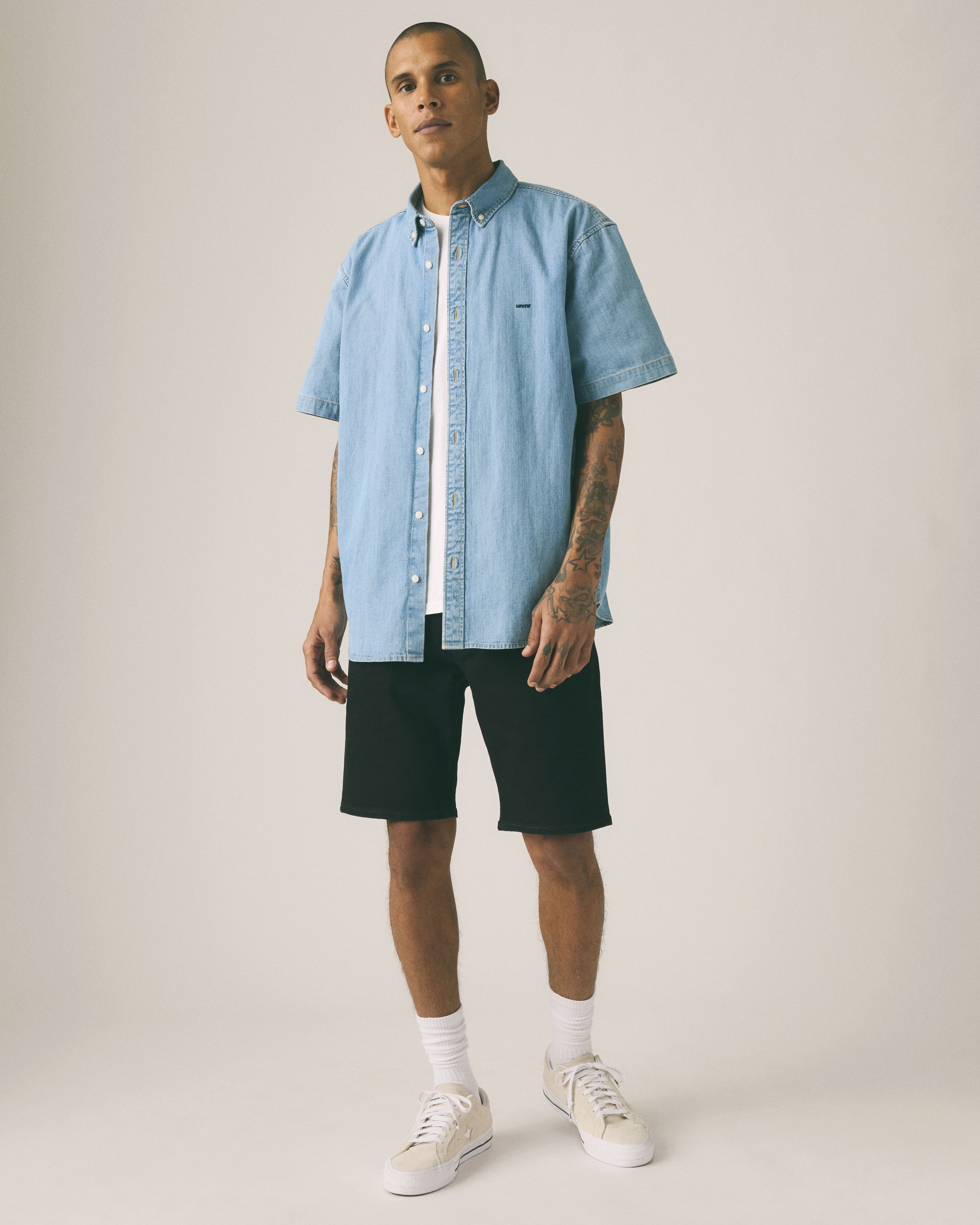 Male model wearing jean shorts.