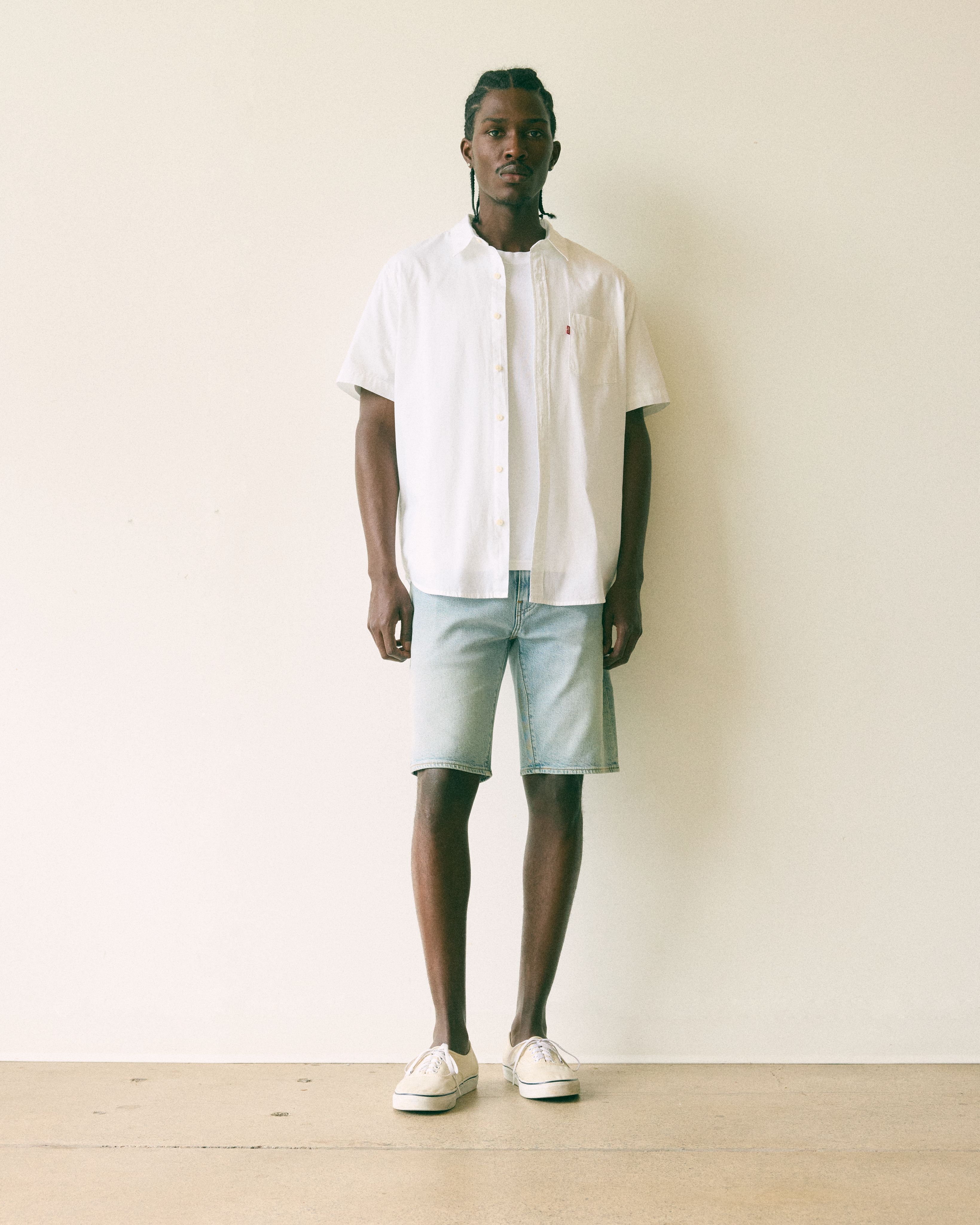 Male model wearing jean shorts.