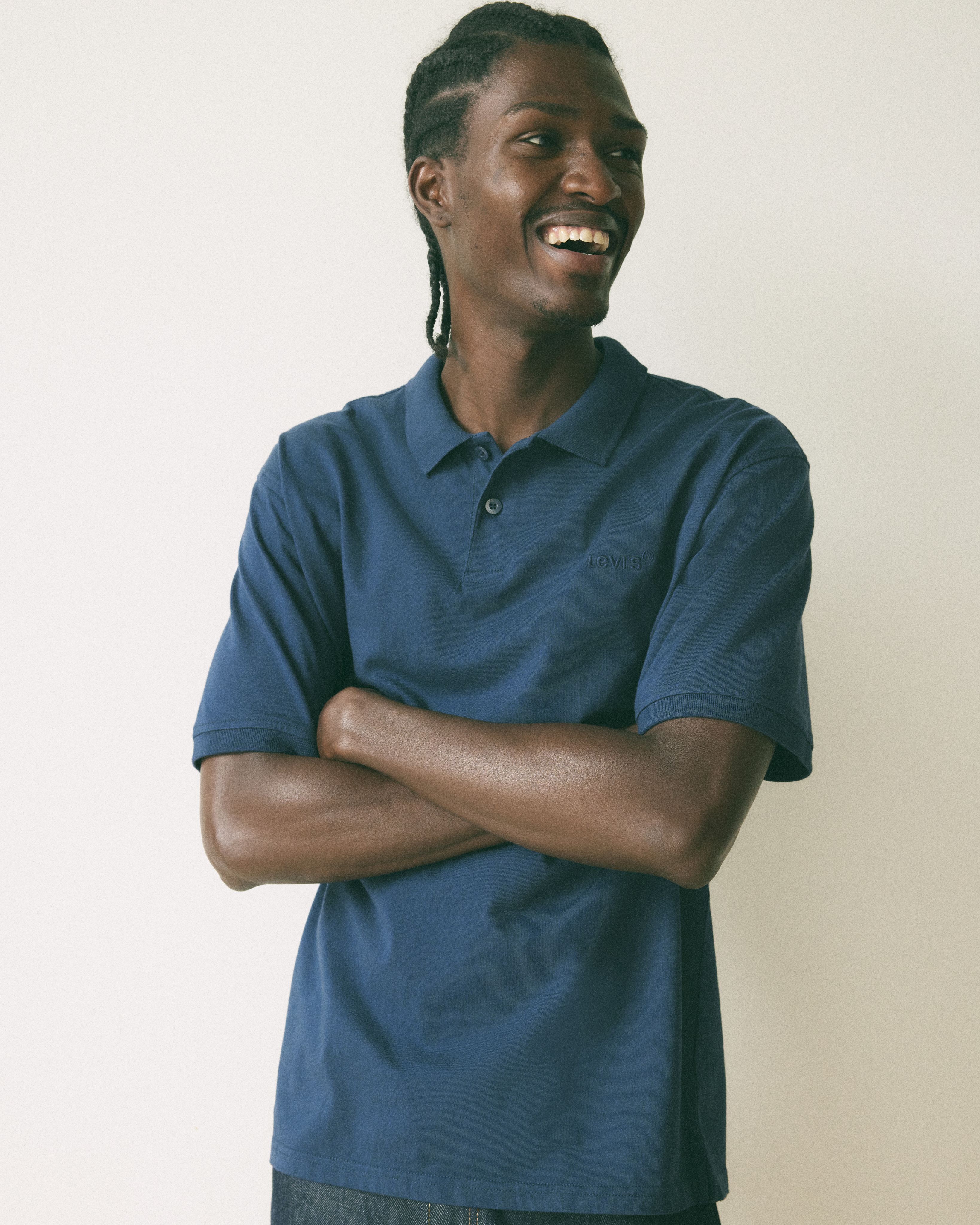 Model wearing a navy blue polo shirt.