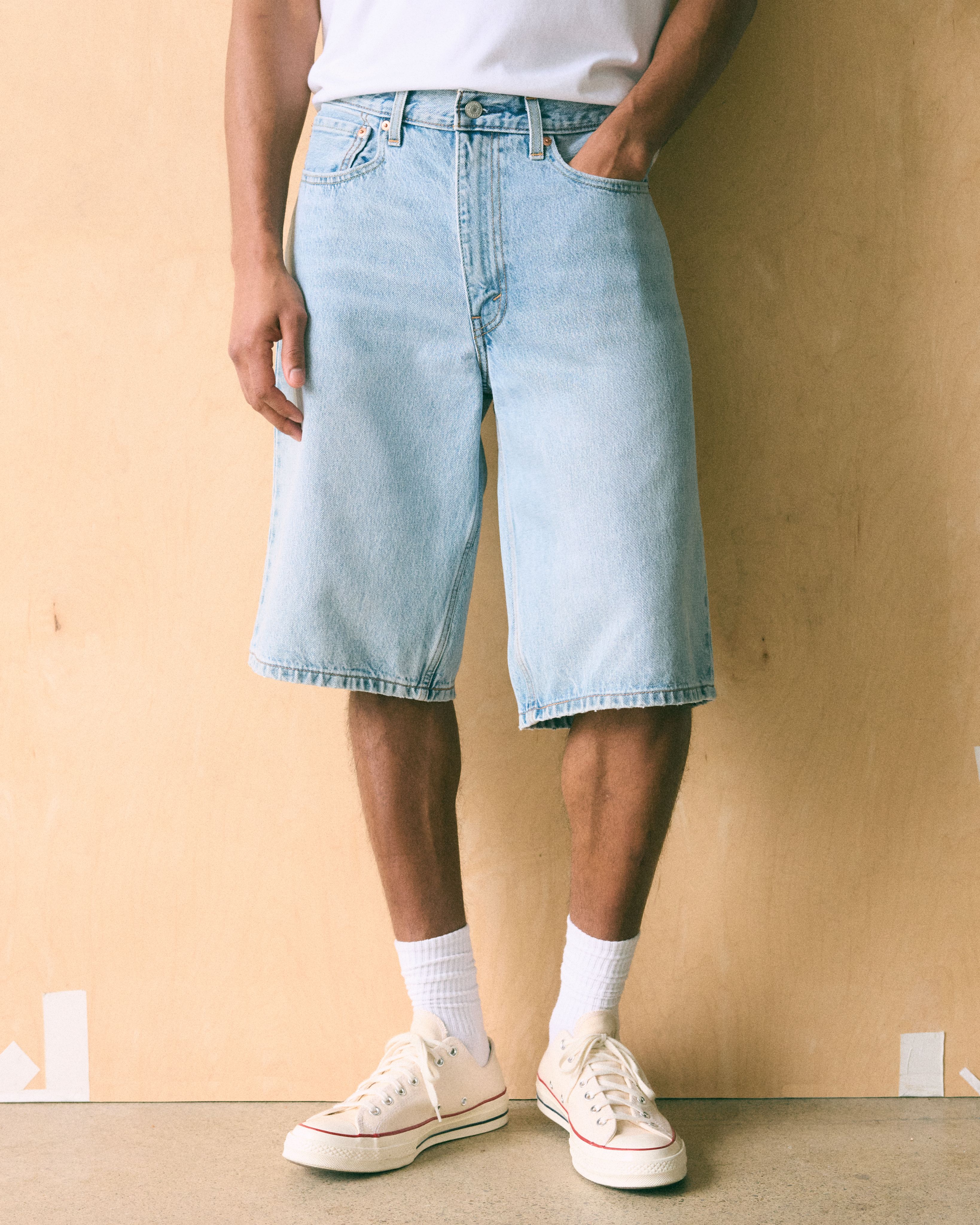 Model wearing denim loose fit shorts