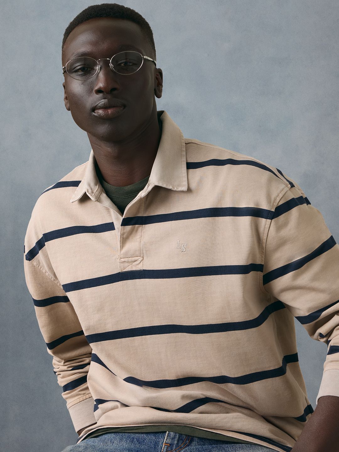 Model wearing a navy blue polo shirt.