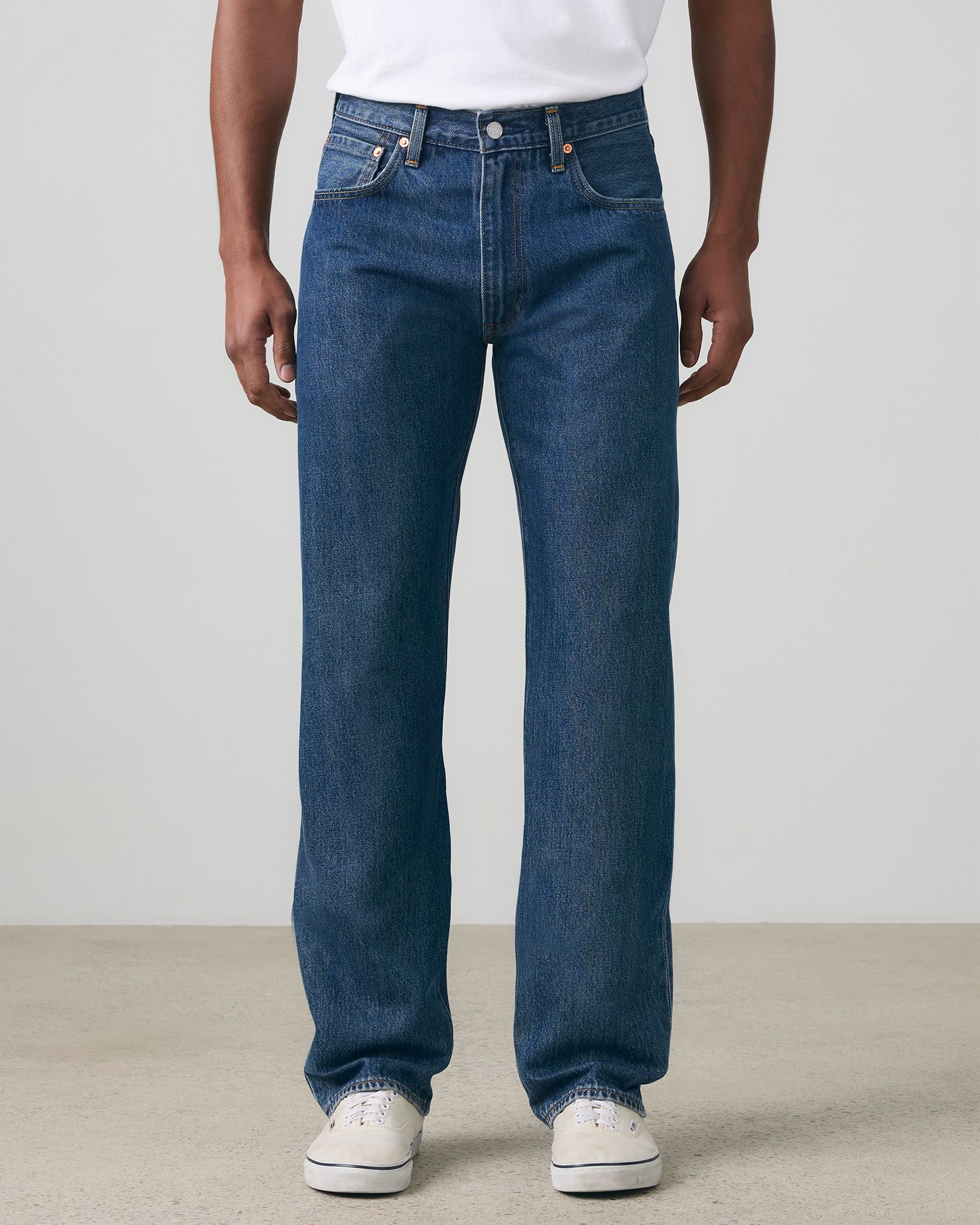 Model wearing tan relaxed fit pants.
