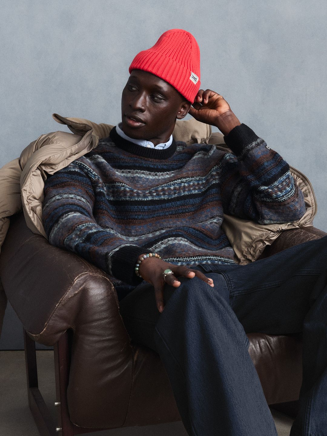 Male model wearing a green sweatshirt.
