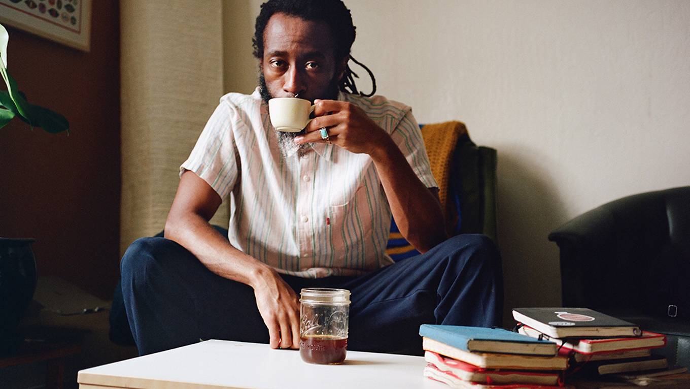 Photo of Joonbug drinking coffee in his home.