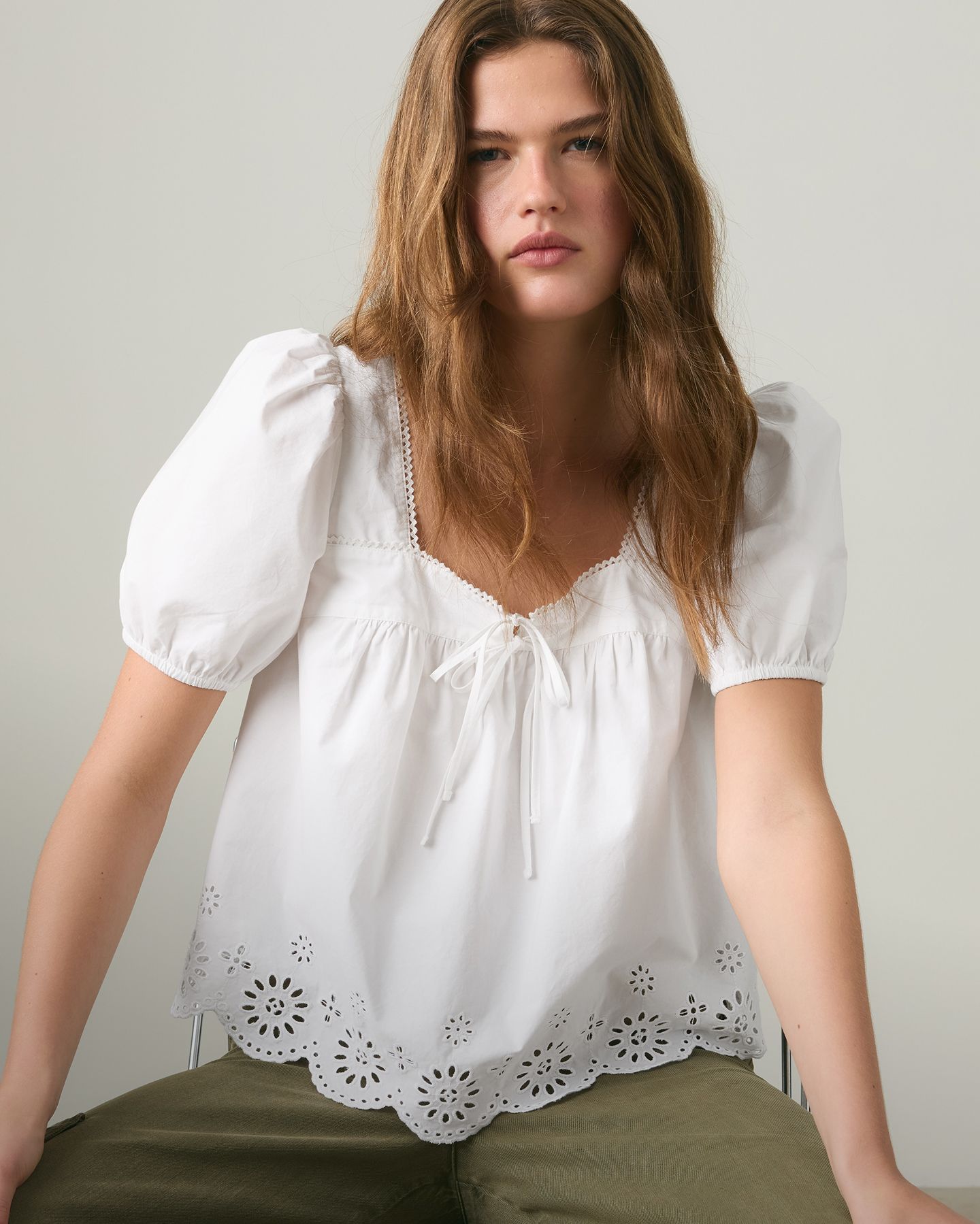 model wearing white blouse