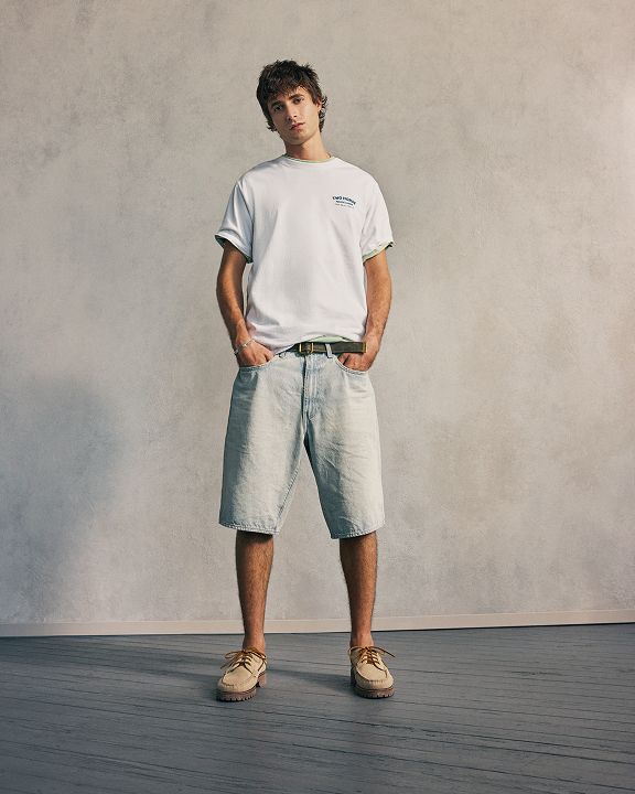model in shorts and graphic tee