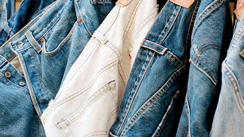 An image of different jeans hanging up