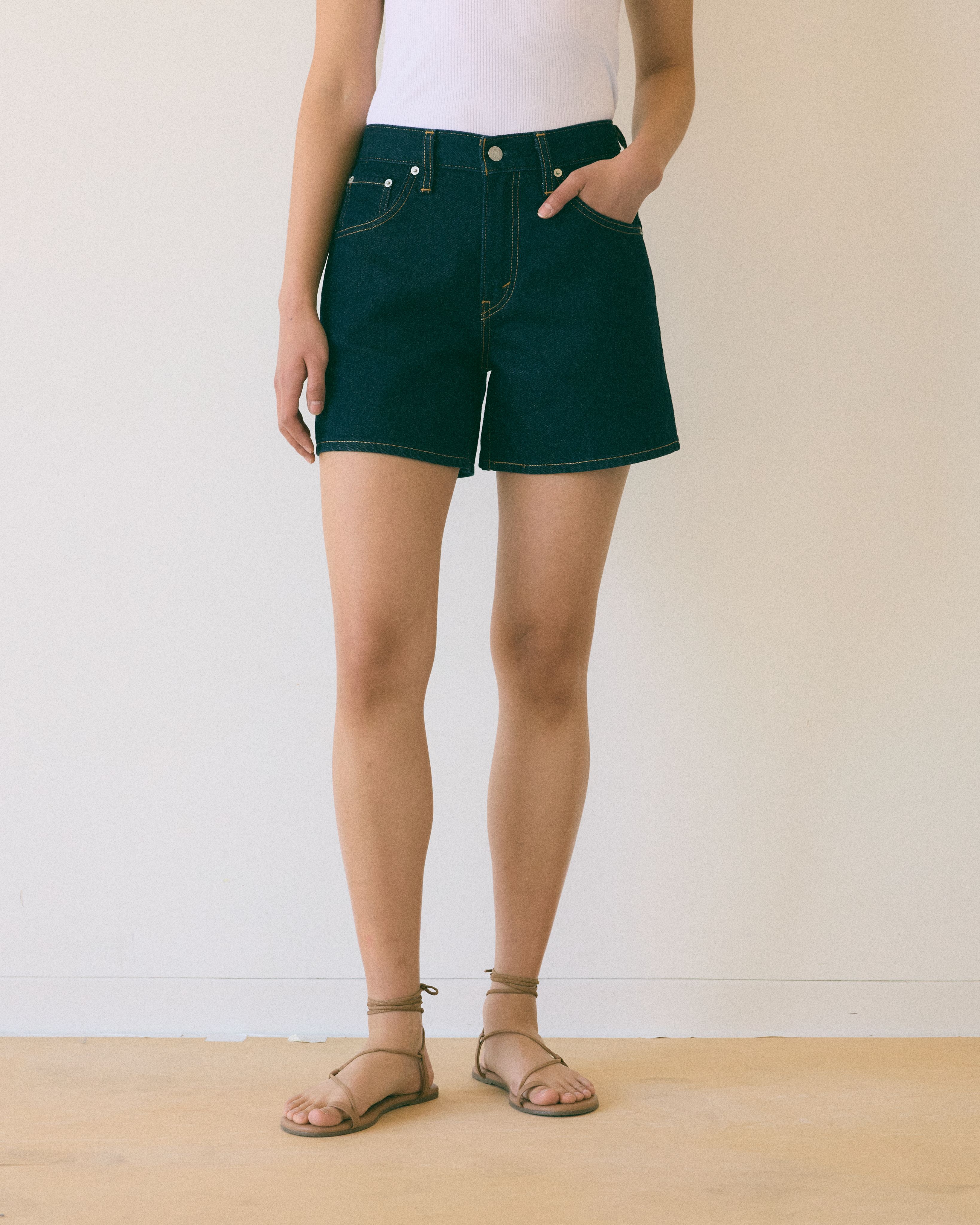Female model wearing cinch mid thigh shorts 