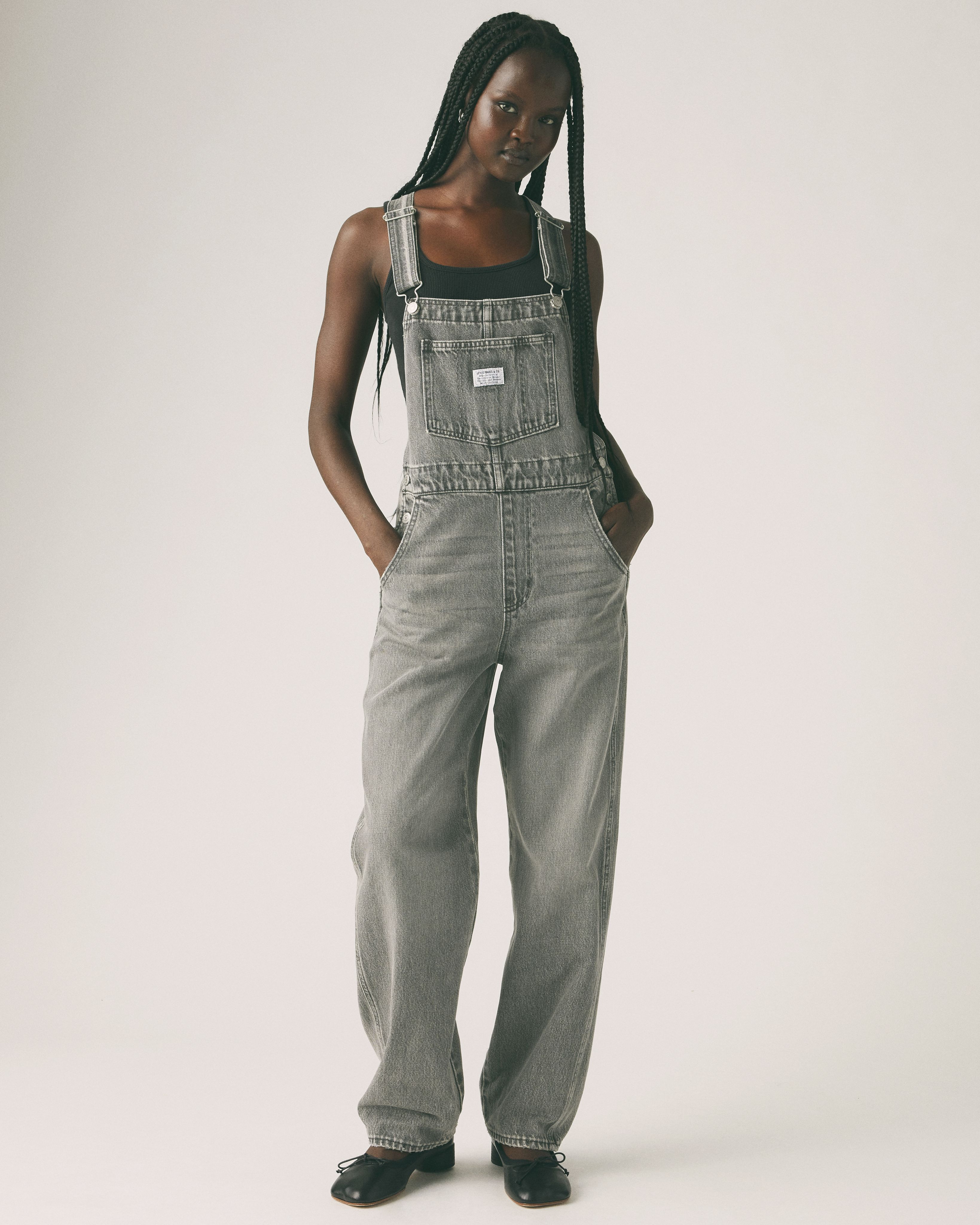 Female model wearing vintage overalls