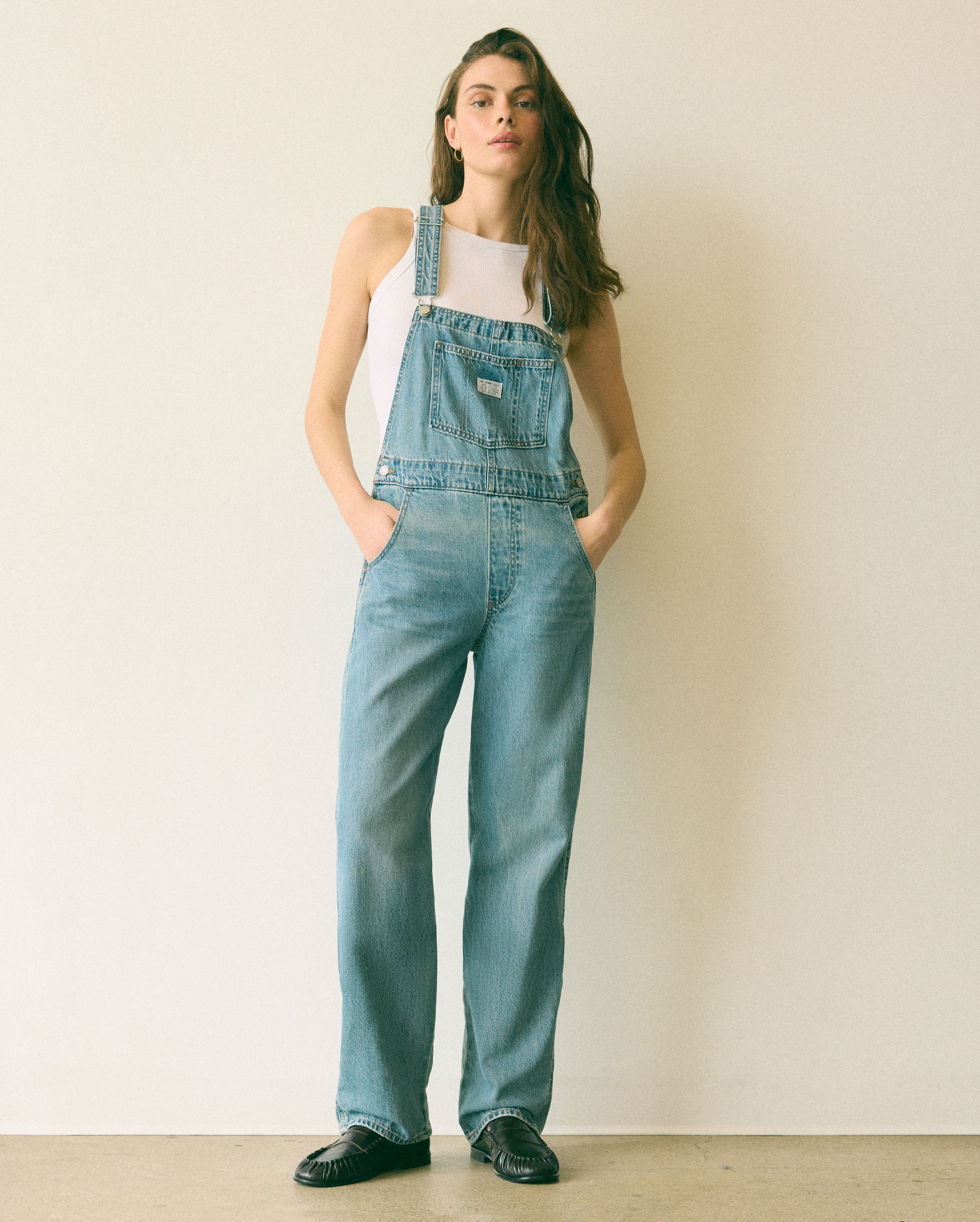 Female model wearing vintage overalls