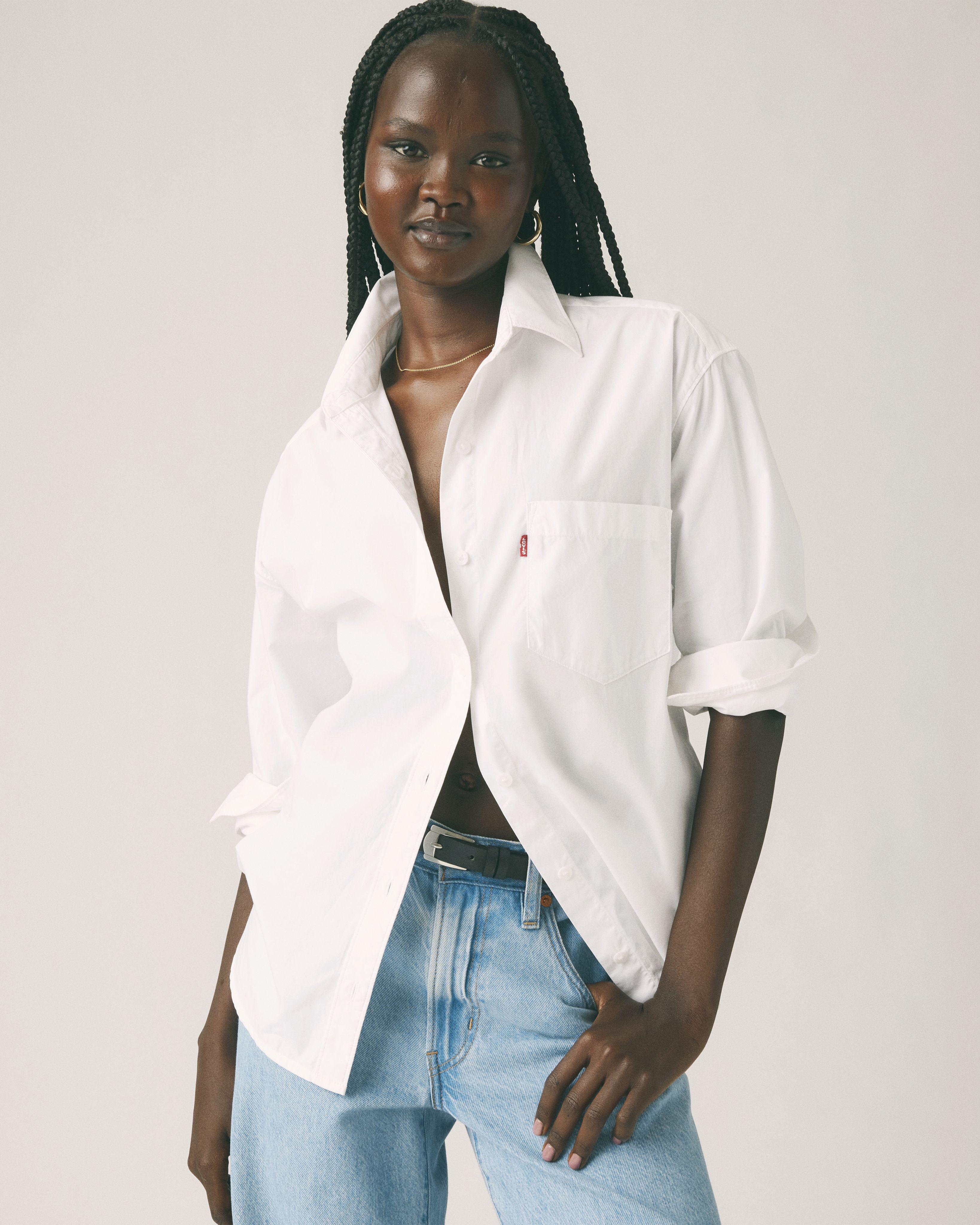 Model wearing white button-up shirt