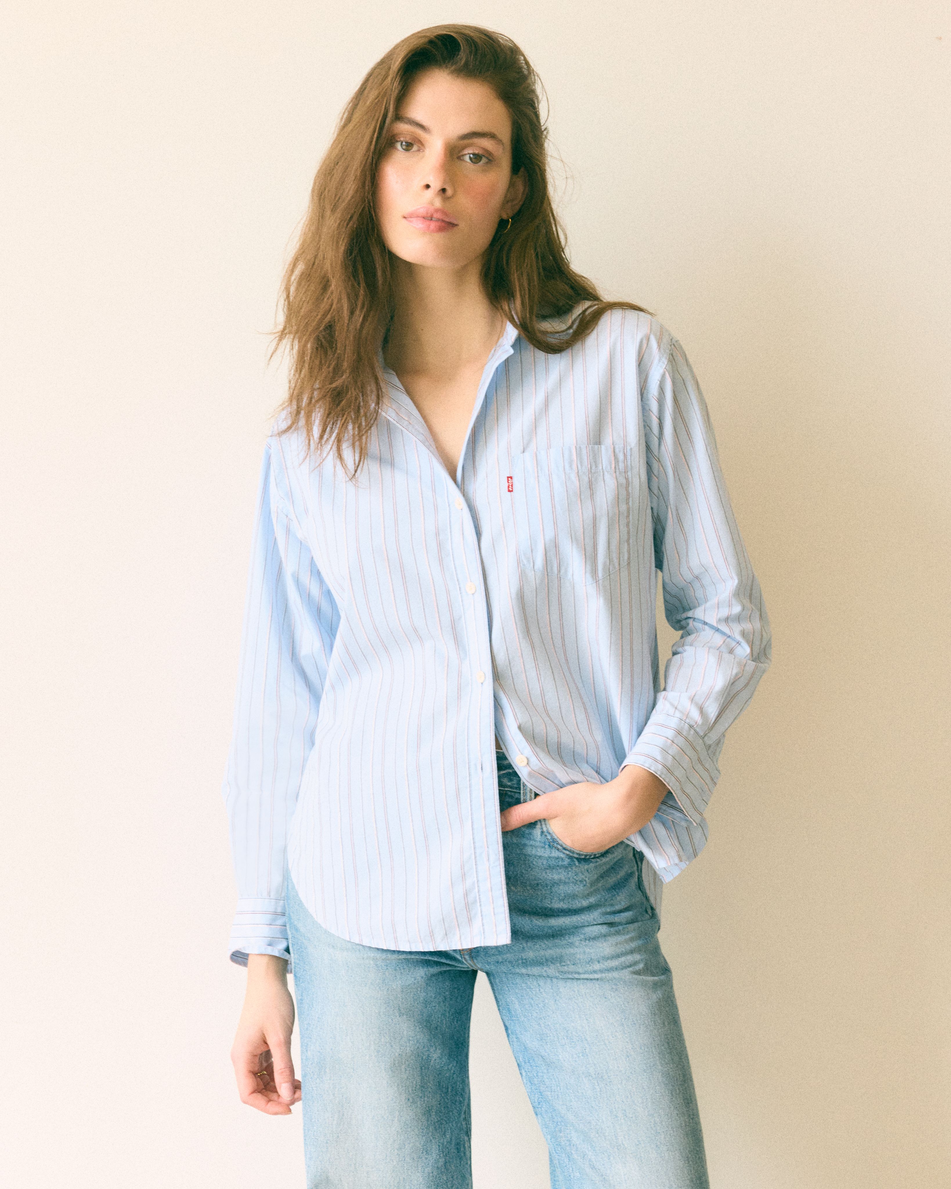 Model wearing white button-up shirt