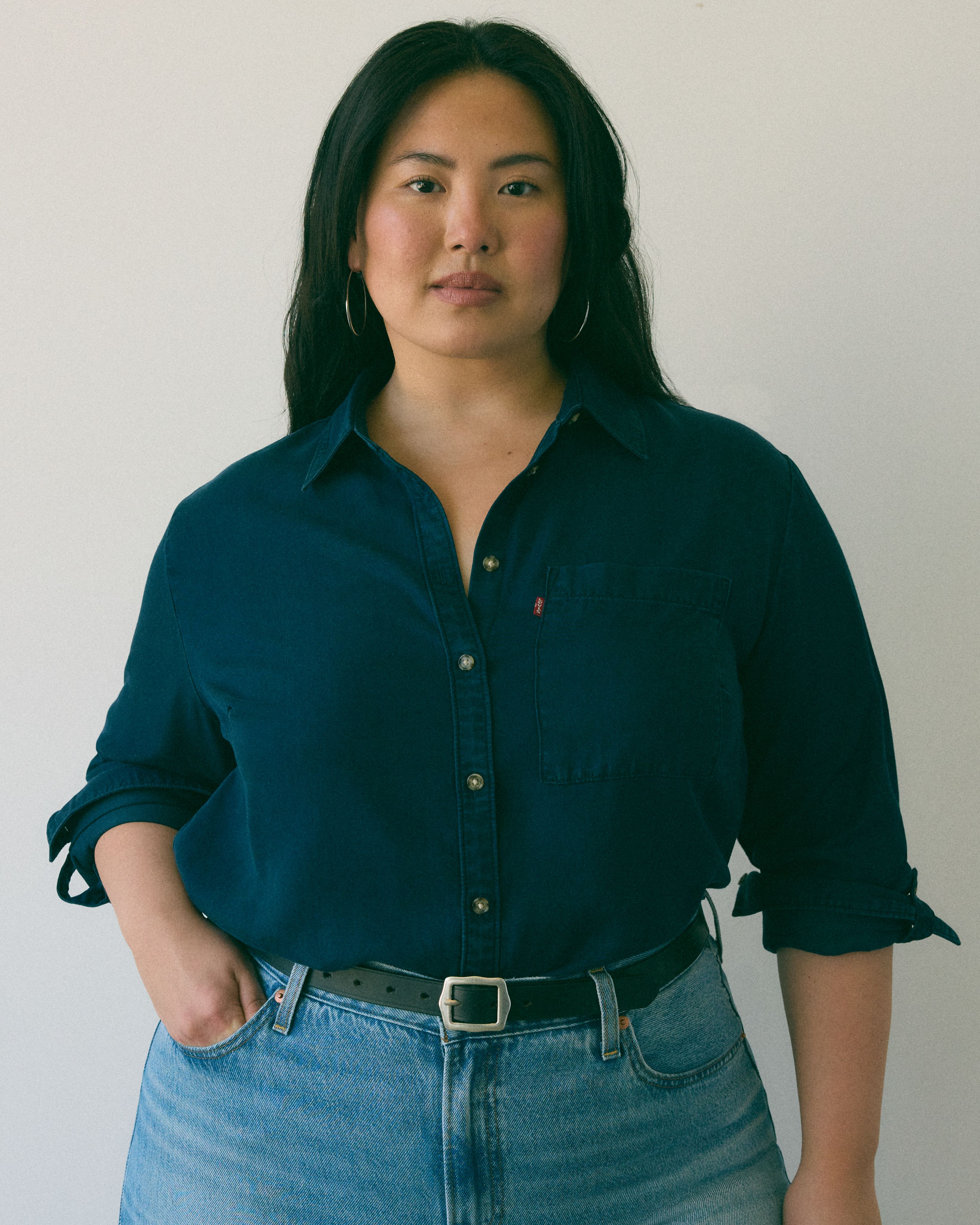 Model wearing blue button-down with red Levi's logo.