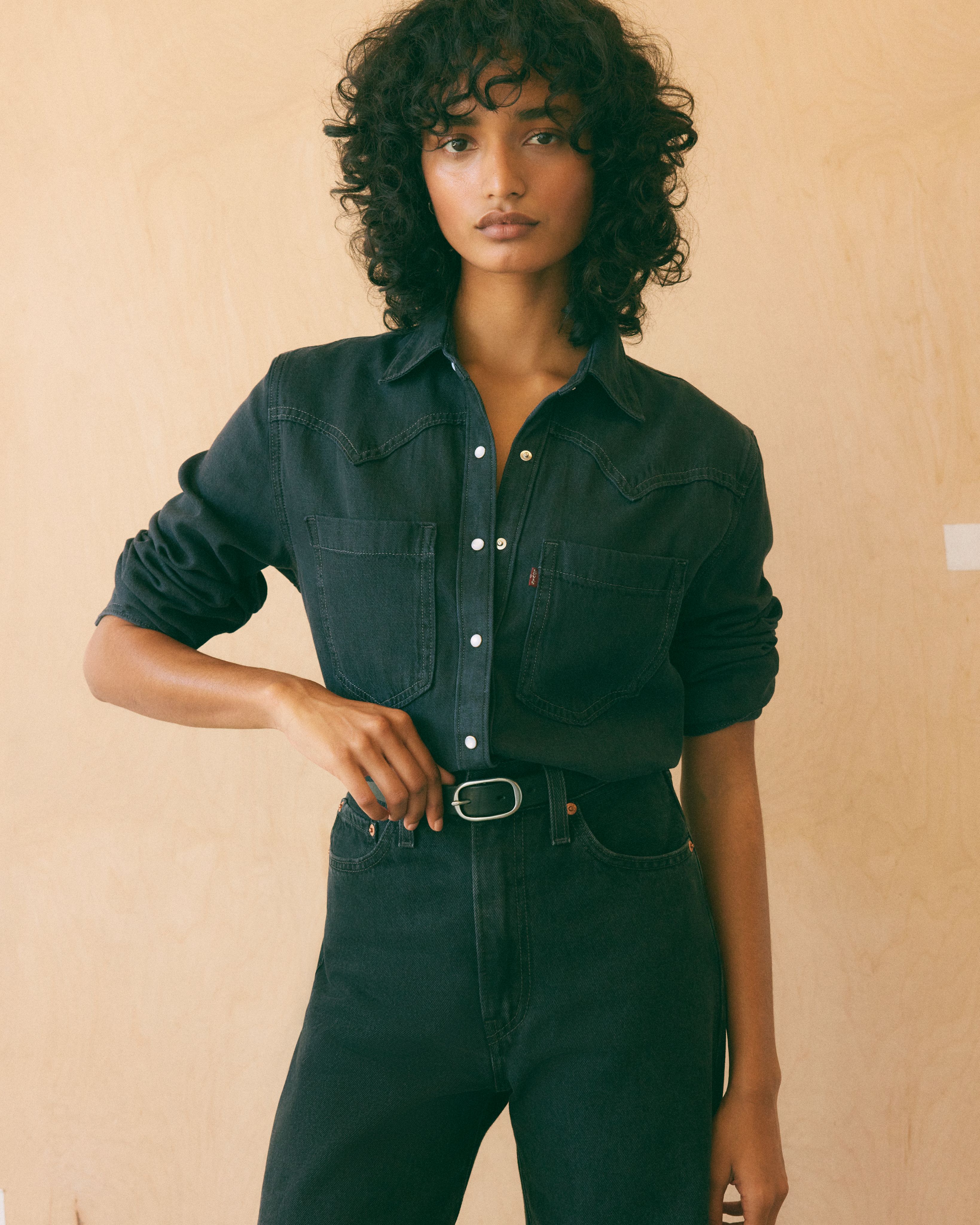 Model wearing western button-up top.