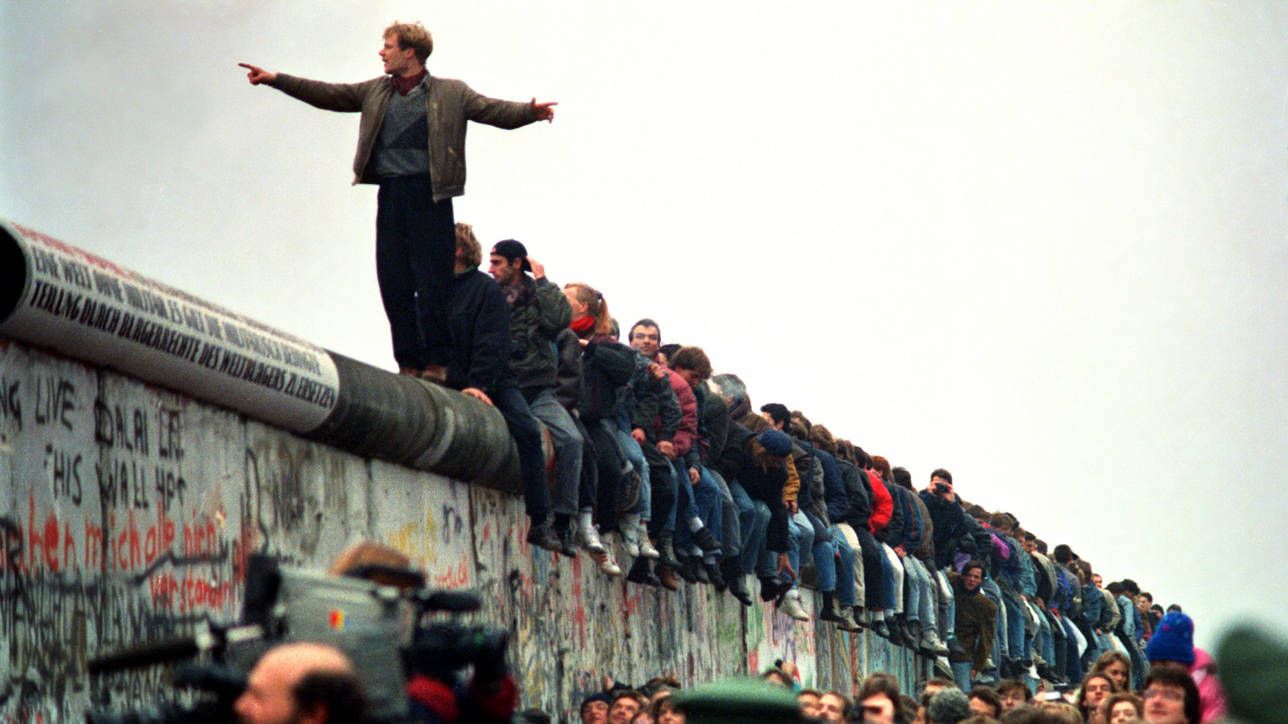 Man standing on a fence.