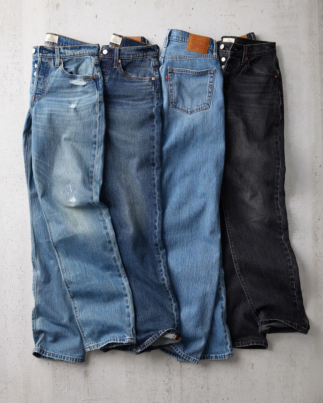 photo of four pair of jeans laid down
