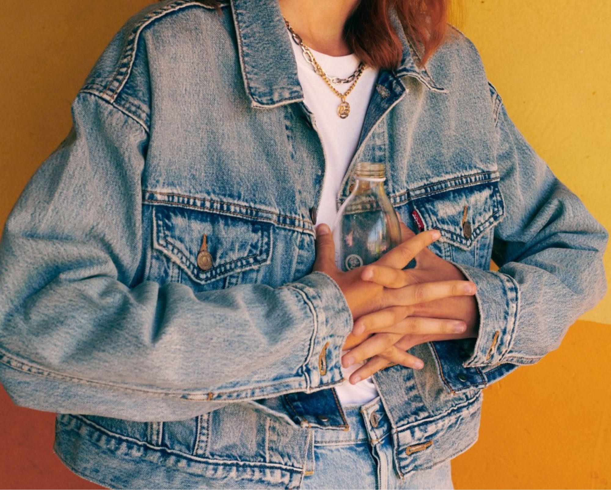 Girl wearing a denim jacket.