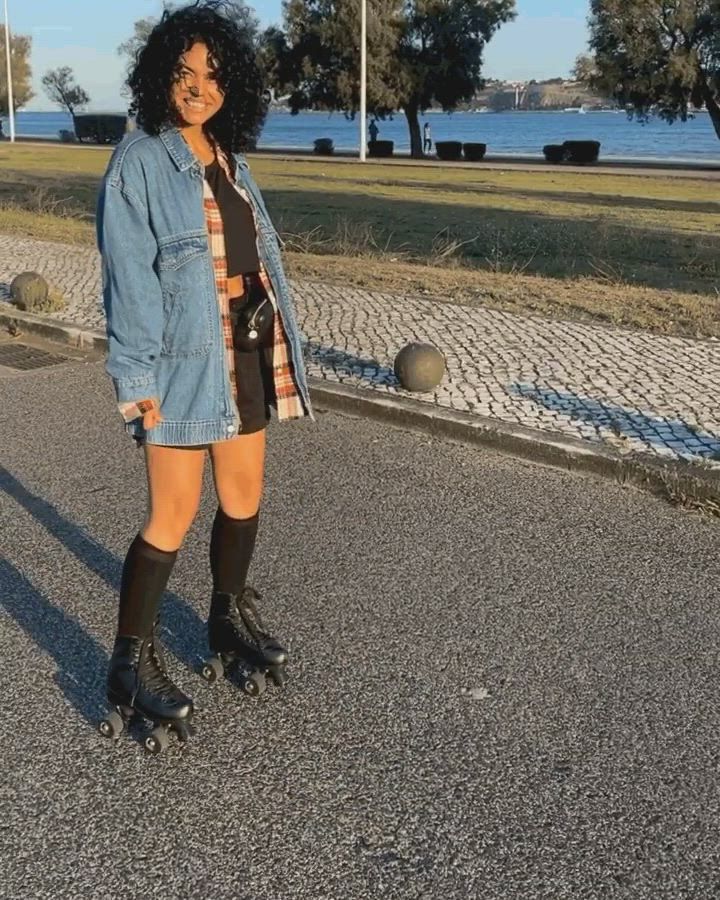 GIF of Micaela Stuart on rollerblades outside.